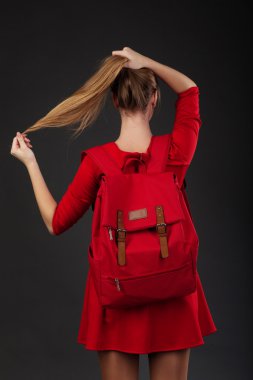Portrait of a girl in red dress, with a big red backpack clipart