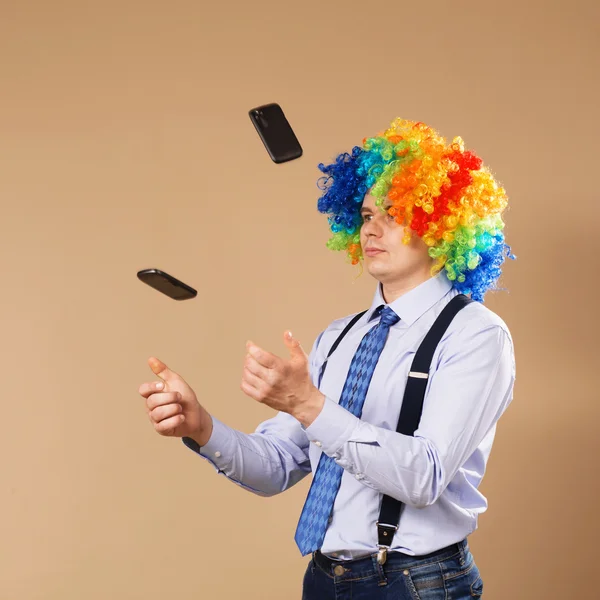 Businessman juggling mobile phones — Stock Photo, Image