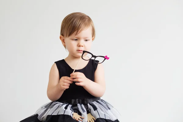 Portrait of a lovely little girl with funny paper glasses — Stock Photo, Image