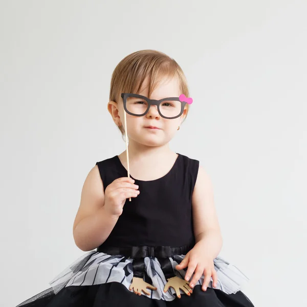 Portrait of a lovely little girl with funny photo props paper gl — Stock Photo, Image