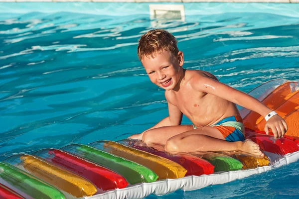 スイミング プールの青い水で遊んで喜んでいる子供. — ストック写真