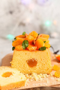 Taze sıkılmış portakal suyu ve kurutulmuş kayısı, nane yaprağı ve bademle süslenmiş aromalı turuncu kek..