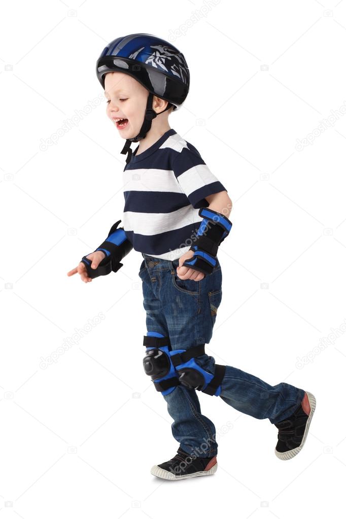 Little boy in protection helmet and in the knee and arm ruffles 