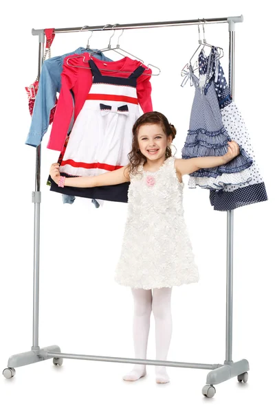 Little fashionable girl chooses clothes in a wardrobe — Stock Photo, Image