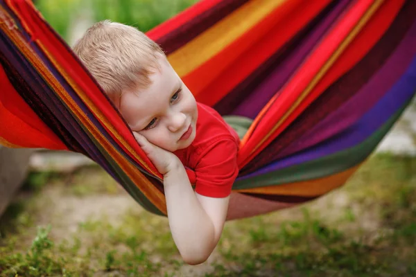 Beautiful cheerful little boy resting in a hammock — Stock Photo, Image