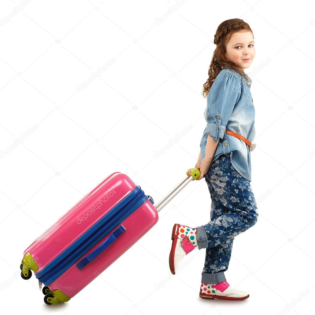 Full-length portrait of a pretty little girl with big pink suitc