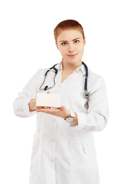 Portrait of a young female doctor in a white coat holding in han — Stock Photo, Image
