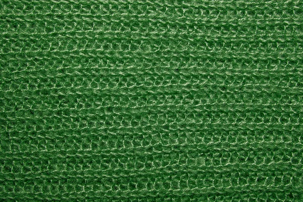 Green fluffy woven thread sweater as a background.