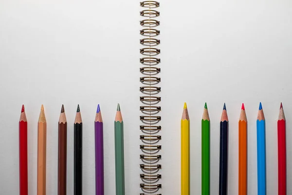 Macro Shot Open Notebook White Sheets Table Lots Colored Pencils — Stock Photo, Image