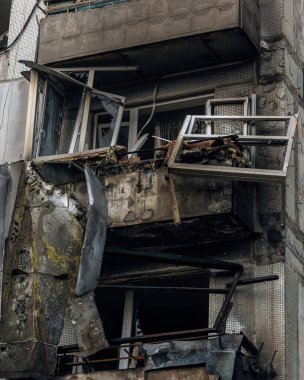 The epicenter of destruction in a residential building after a military attack. Catastrophic damage to balconies and faade, critical damage to residential infrastructure.