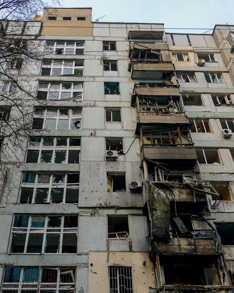 A general vertical view of the apartment building's faade after the shelling. The central balcony column was critically damaged and collapsed. The extent of the damage