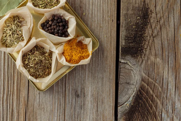 Herbs and spices on wooden table top view — Stock Photo, Image