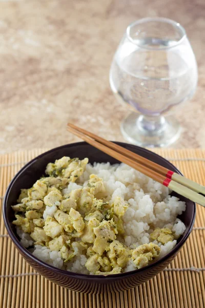 Bowl with rice and chicken and sticks — Stock Photo, Image