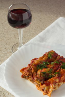 Stuffed meat cannelloni and glass of wine clipart