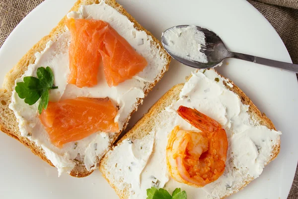 Vete bröd rostat bröd med färskost, rökt lax och räkor — Stockfoto