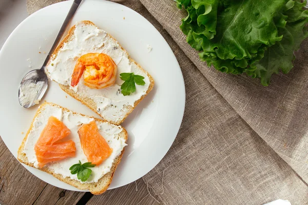 Tostadas de pan de trigo con queso crema, salmón ahumado y camarones —  Fotos de Stock