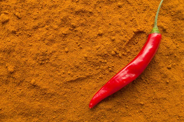 Chili pepper pod on chili powder top view