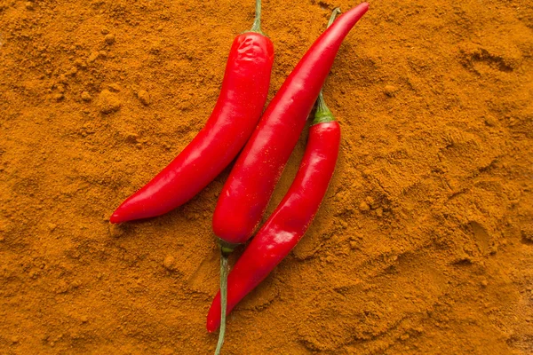 Chili pepper pods on chili powder top view