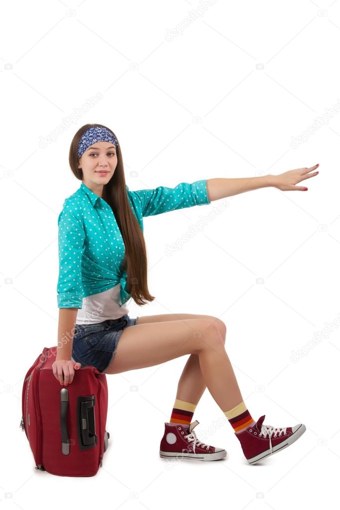 Girl sitting on the her suitcase and stops the car