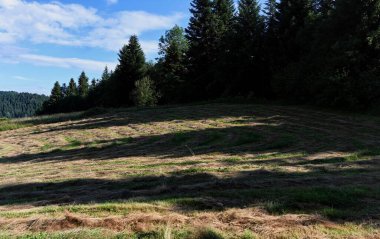 Clouds over the Ochotnica Gorna vilage hills during summer day