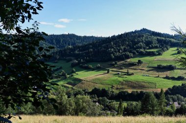 Clouds over the Ochotnica Gorna vilage hills during summer day