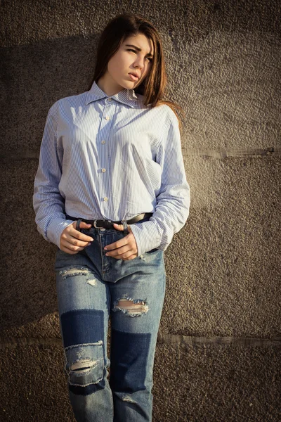 Pretty teenage girl in a shirt and jeans — Stock Photo, Image