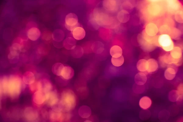 Abstract defocused background with purple and gold circular blur