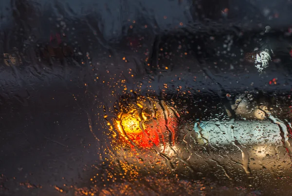 Blurry car silhouette seen through molten snow and water drops o — Stock Photo, Image