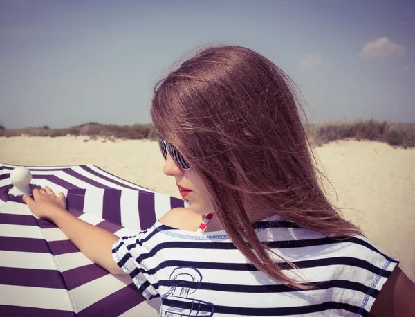 Portrait of a stylish girl in a striped t-shirt and sunglasses b — Stock Photo, Image