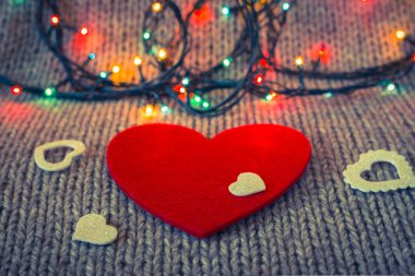 Küçük beyaz dekoratif kalp kırmızı keçe kalp üzerinde