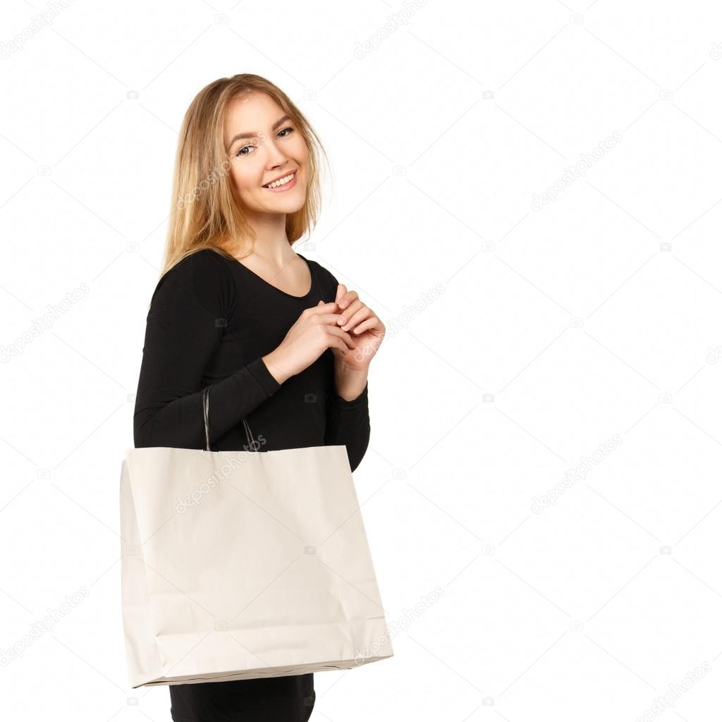 Young woman in a black dress with shopping bags, isolated on a white background.