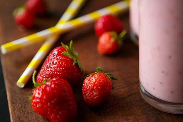 Batido de fresa y plátano en el vaso sobre fondo negro — Foto de Stock