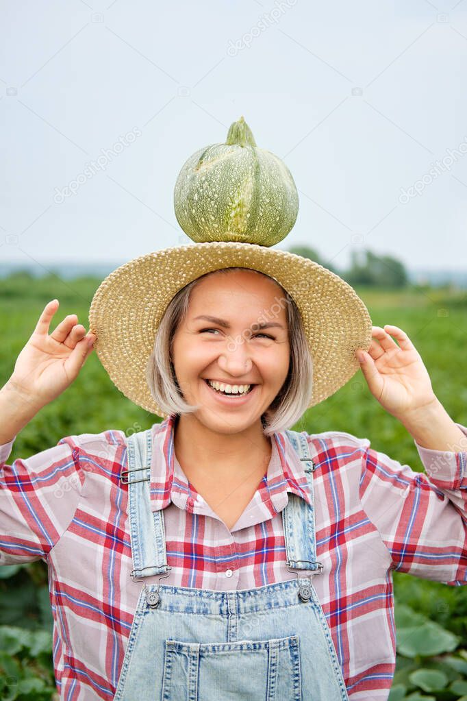 Woman Holding Green Fresh Pumpkin on Plants Field