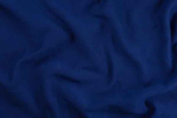 Achtergrond van blauwe monochrome katoenen stof. Close-up textuur — Stockfoto