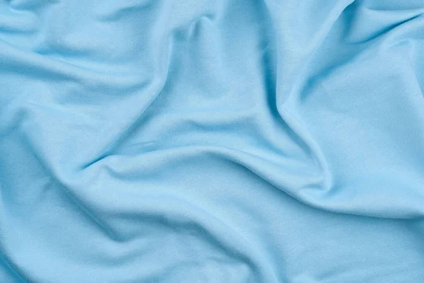 Tło z jasnoniebieskiej tkaniny bawełnianej monochromatycznej. — Zdjęcie stockowe
