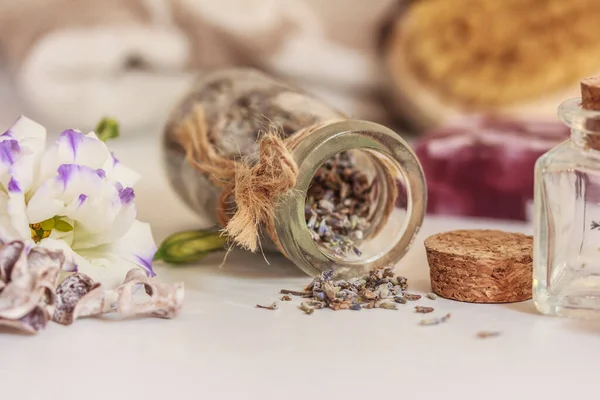 Lavender herbs, flower, soap, beautiful decorative bottles, essential oil, flesh brush on white background.  Body care.  Lavender spa. Side view, stock photo