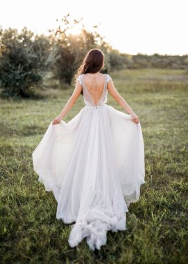 Beyaz elbiseli güzel gelinin yeşil çayırda dikiz aynasından.