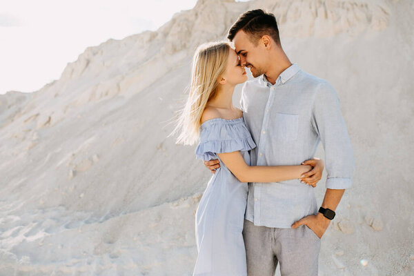 beautiful young couple embracing in sand quarry