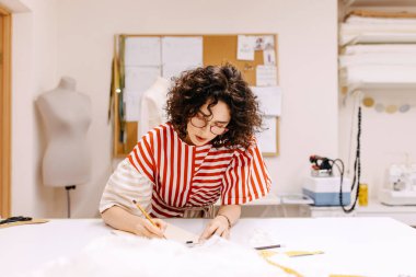 Atölyede gelinlik tasarlayan terzi.