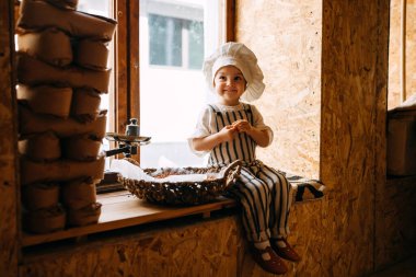 portrait of girl child preparing corn flour clipart