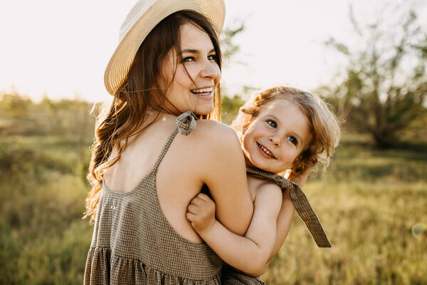 beautiful happy mother and son spending time together on nature