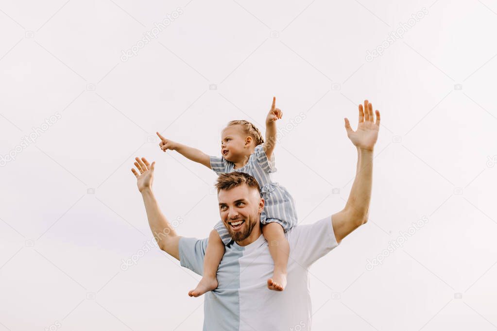 portrait of father and daughter playing together on nature