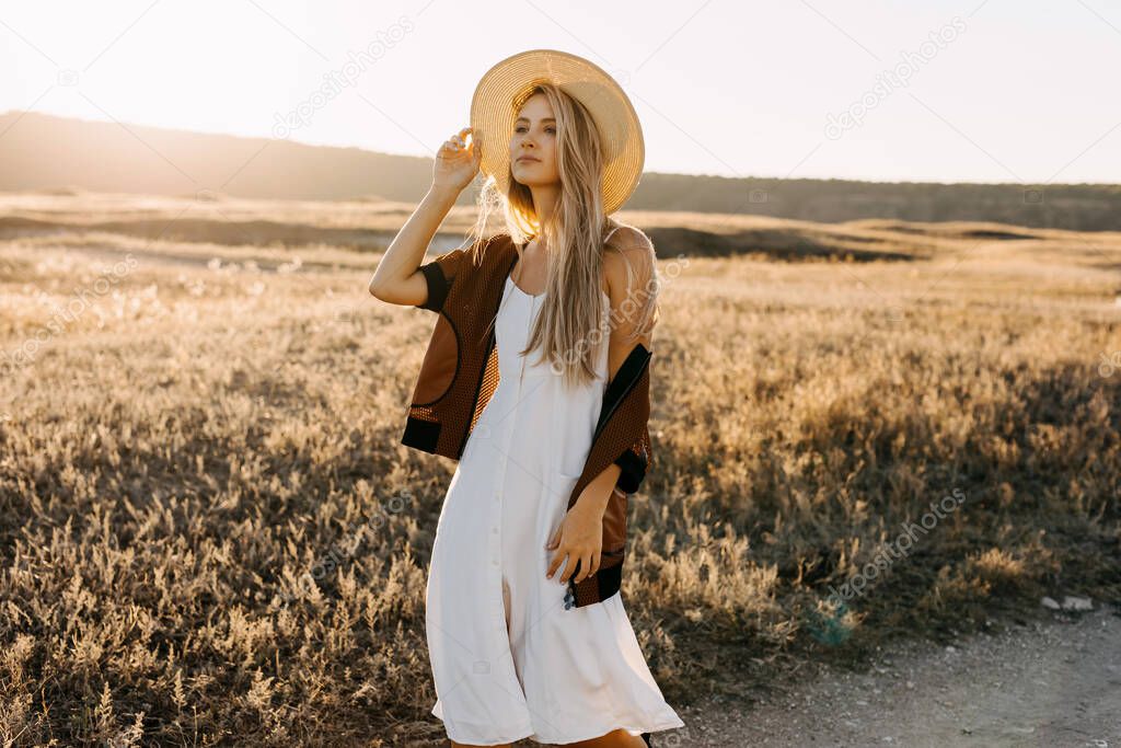 portrait of beautiful blonde woman on nature during sunset