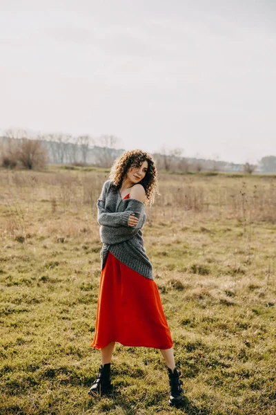 Young Woman Curly Hair Wearing Oversized Sweater Red Dress Field — Stock Photo, Image