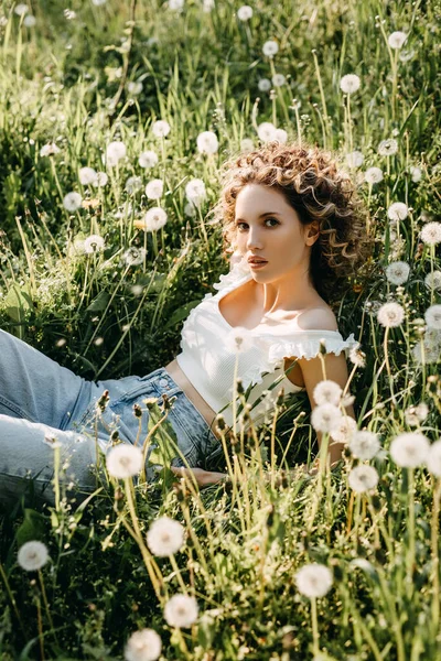 Young Woman Curly Hair Lying Meadow Green Grass Dandelions — Foto de Stock