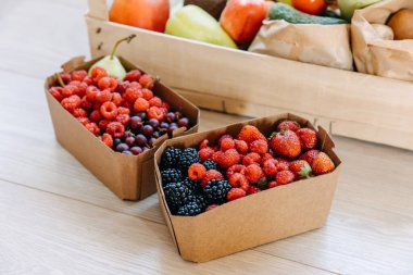 Boxes full of various organic berries. Food delivery concept.
