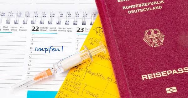 Vaccination certificate and passport on calendar with date for vaccination