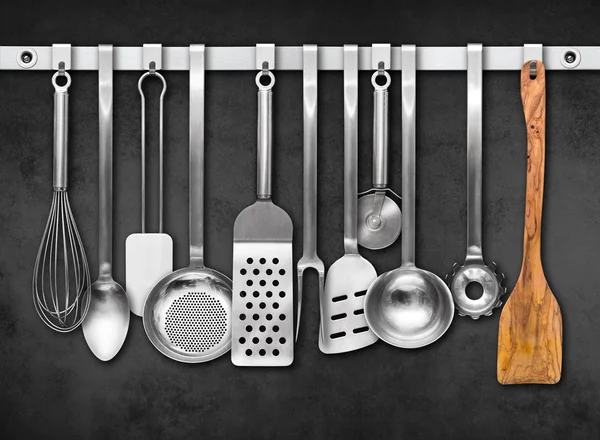 Metal rail with kitchen tools — Stock Photo, Image