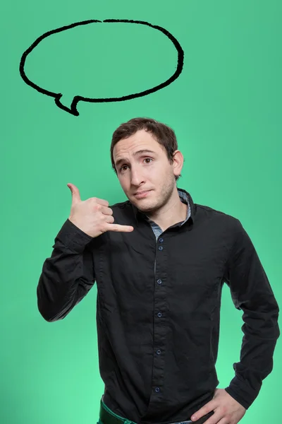 Young man holding his hand as telephone gesture — Stok fotoğraf