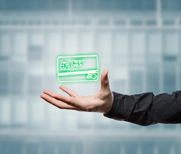 Businessman holding a virtual credit card — Stock Photo, Image